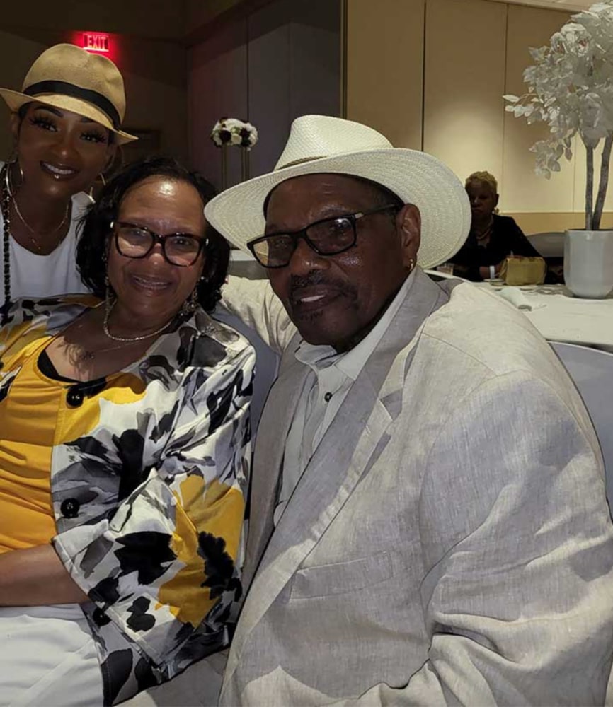 Jacqueline Bernice Mitchell with mother Gloria Campbell and father Coach Mitchell in a photo